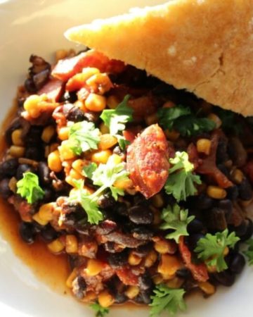 An easy and delicious one pan meal, this smoked sausage skillet is made with black beans, corn, and tomatoes for a hearty and filling dinner.