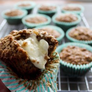 A fresh and warm Apple Oatmeal Muffin with melted butter.