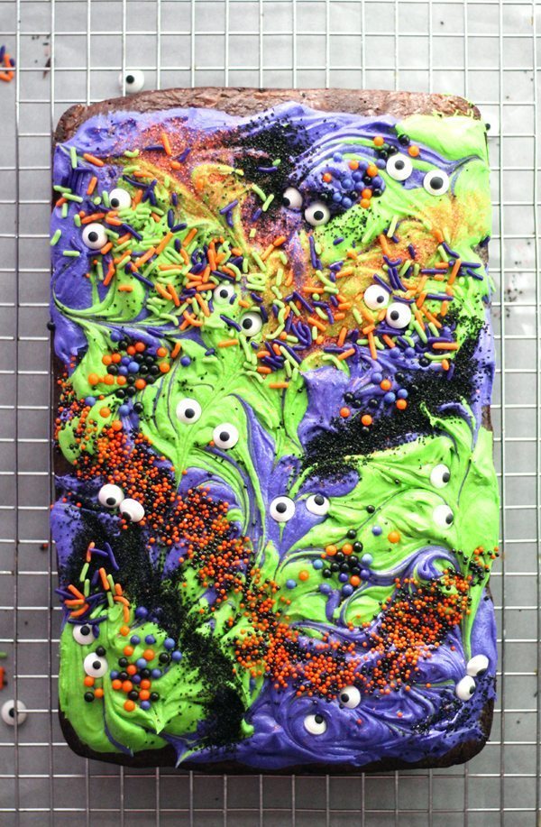 Halloween brownies swirled with frosting and sprinkles, cooling on a wire rack