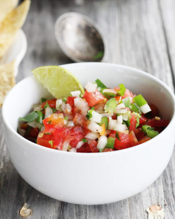 Bold lime juice, cilantro, jalapenos and habanero make this Garden Tomato Salsa amazing. Every bite is full of fresh tomatoes, peppers and flavor.