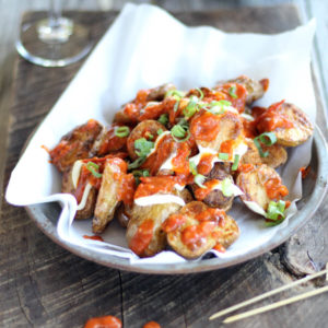 Patatas Bravas is an addictive appetizer that starts with crisp oven-roasted potatoes and is topped with a to-die-for homemade garlic tomato sauce.