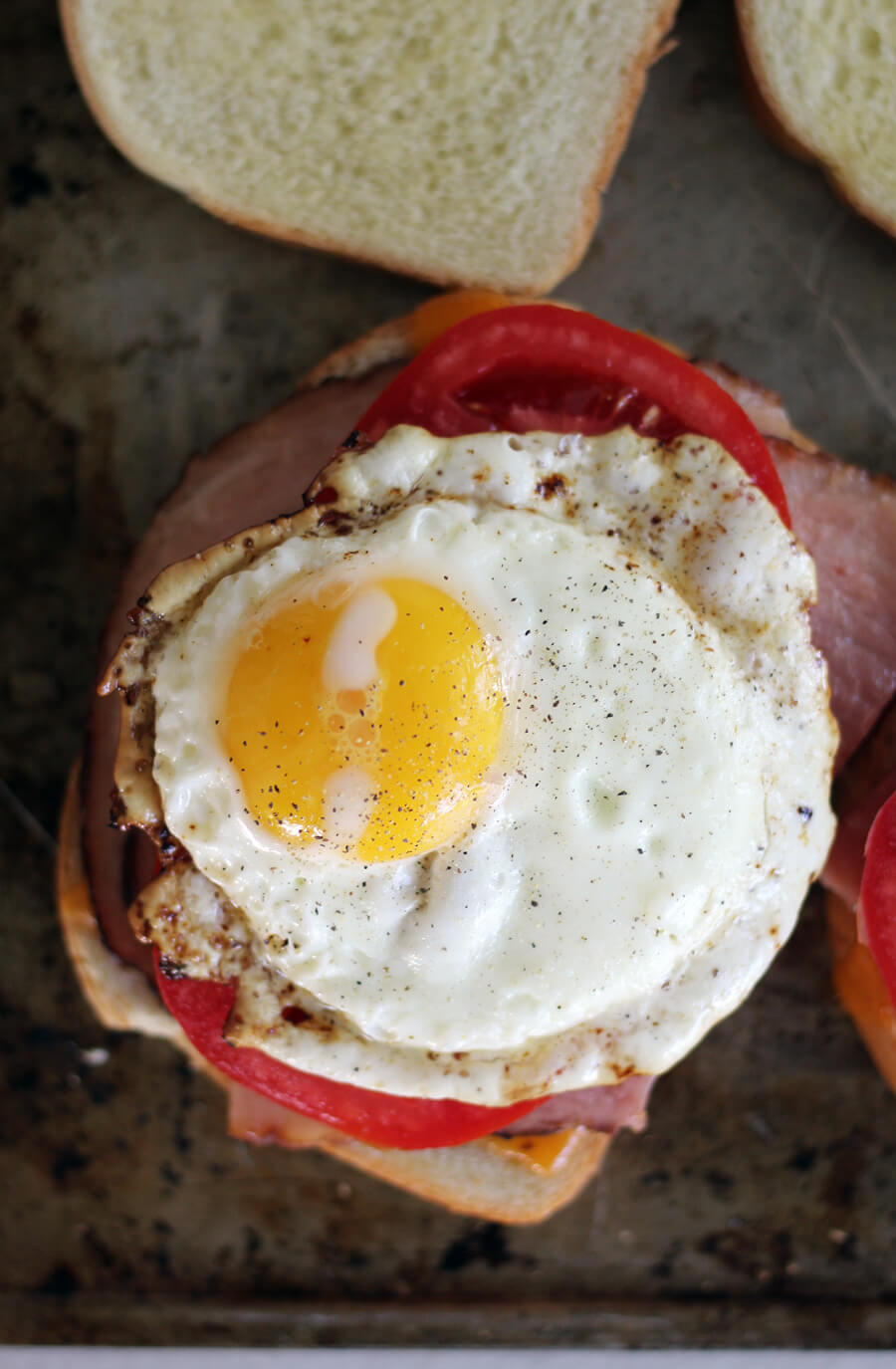 overhead picture of a fried egg on a ham sandwich