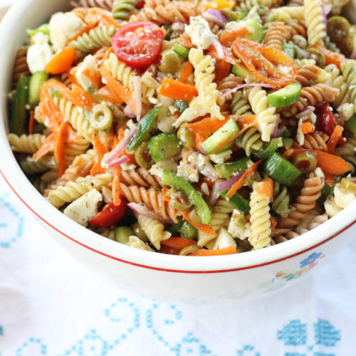 Italian Pasta Salad recipe. Seriously, this is the recipe that my family asks me to make for all of our gatherings. Loaded with colorful veggies and tri-color pasta, this side dish is easy to make ahead. My kids can't stop eating it, either. The best part is how easy it is to make with a few basic tips. And our not-so-secret ingredient. :)
