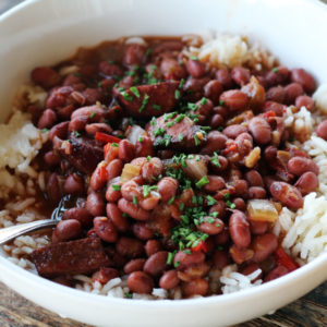 a white bowl with beans and rice