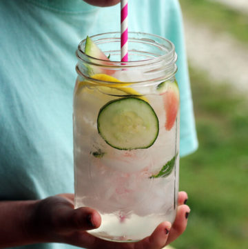 a mason jar with ice water infused with watermelon, cucumber, lemon and mint